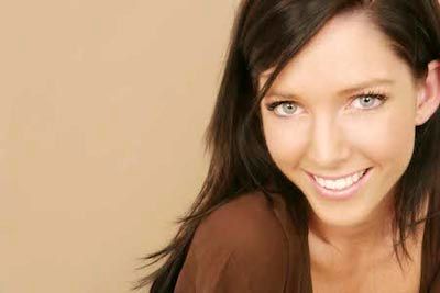 patient smiling after dental bonding repaired her smile